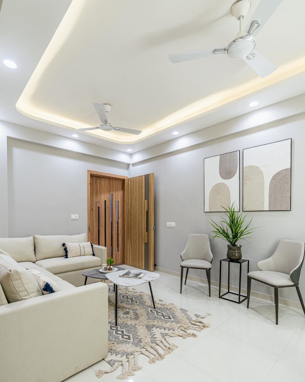 Beige sectional sofa and large grey abstract artwork in a modern living room.