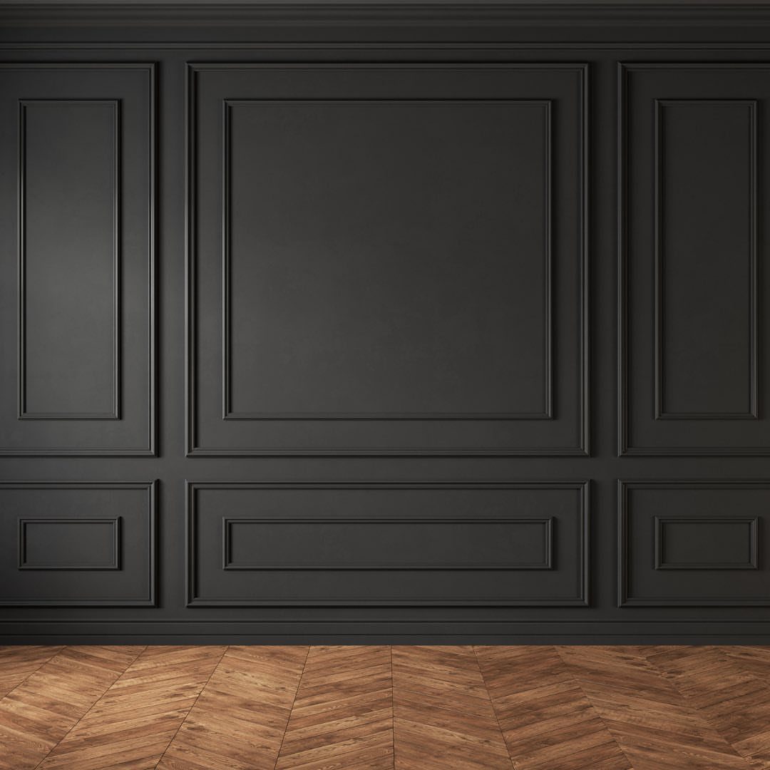 Black wall with framed molding and wainscoting above a herringbone wood floor