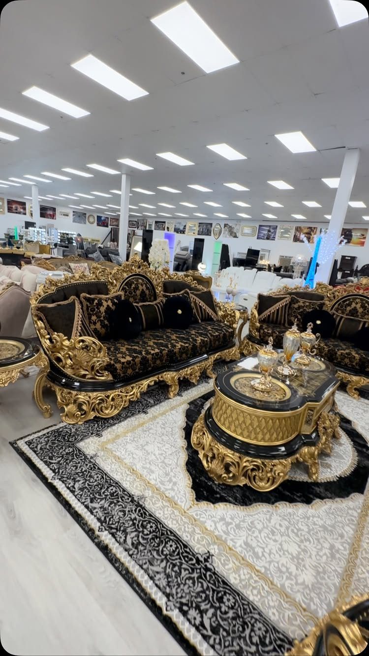 17 Black and Gold Living Room Ideas for Luxe Style 13 Ornate black and gold velvet sofa and coffee table on a patterned rug.