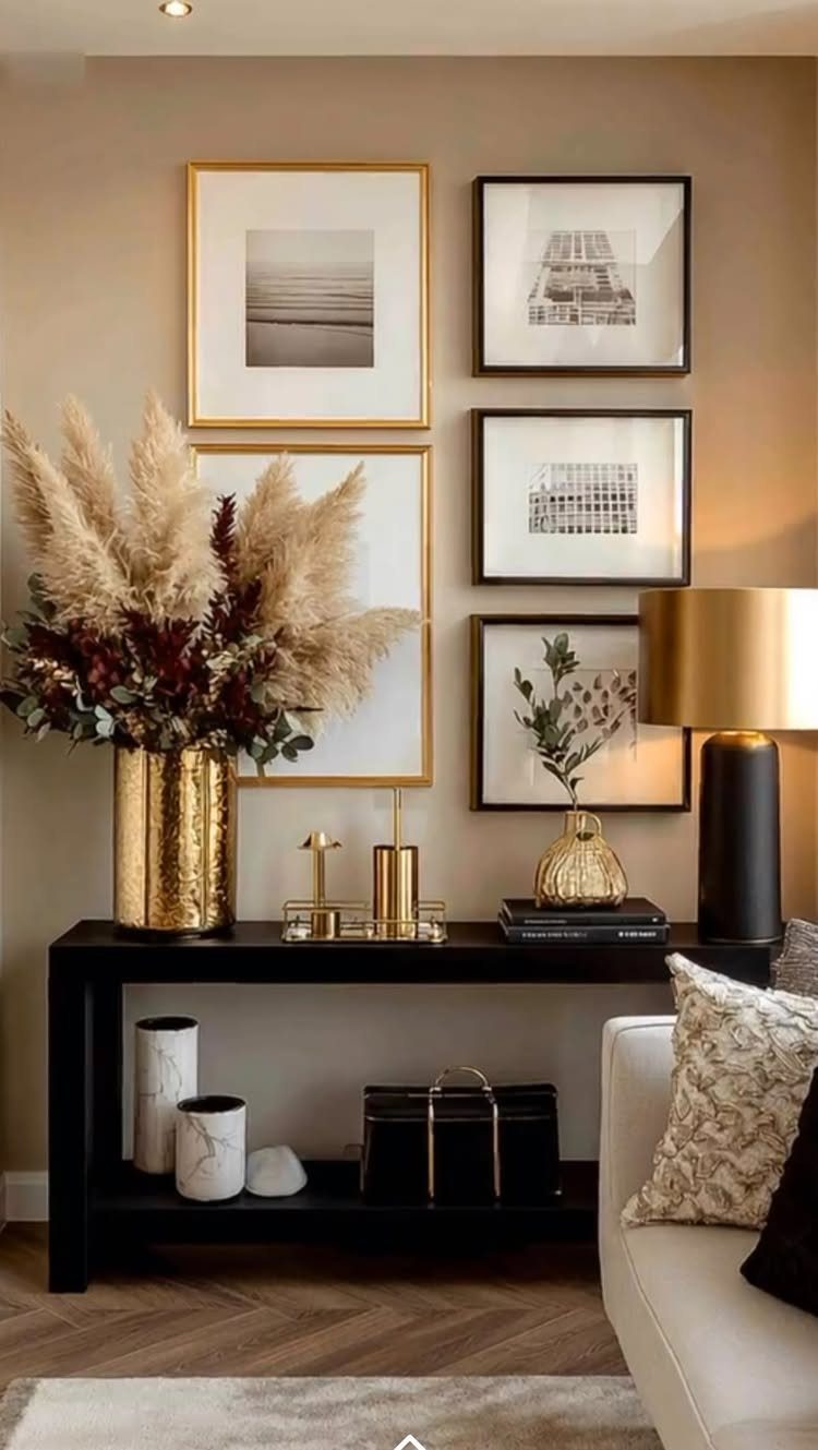 17 Black and Gold Living Room Ideas for Luxe Style 16 Black console table with gold accents and framed art in a modern living room.