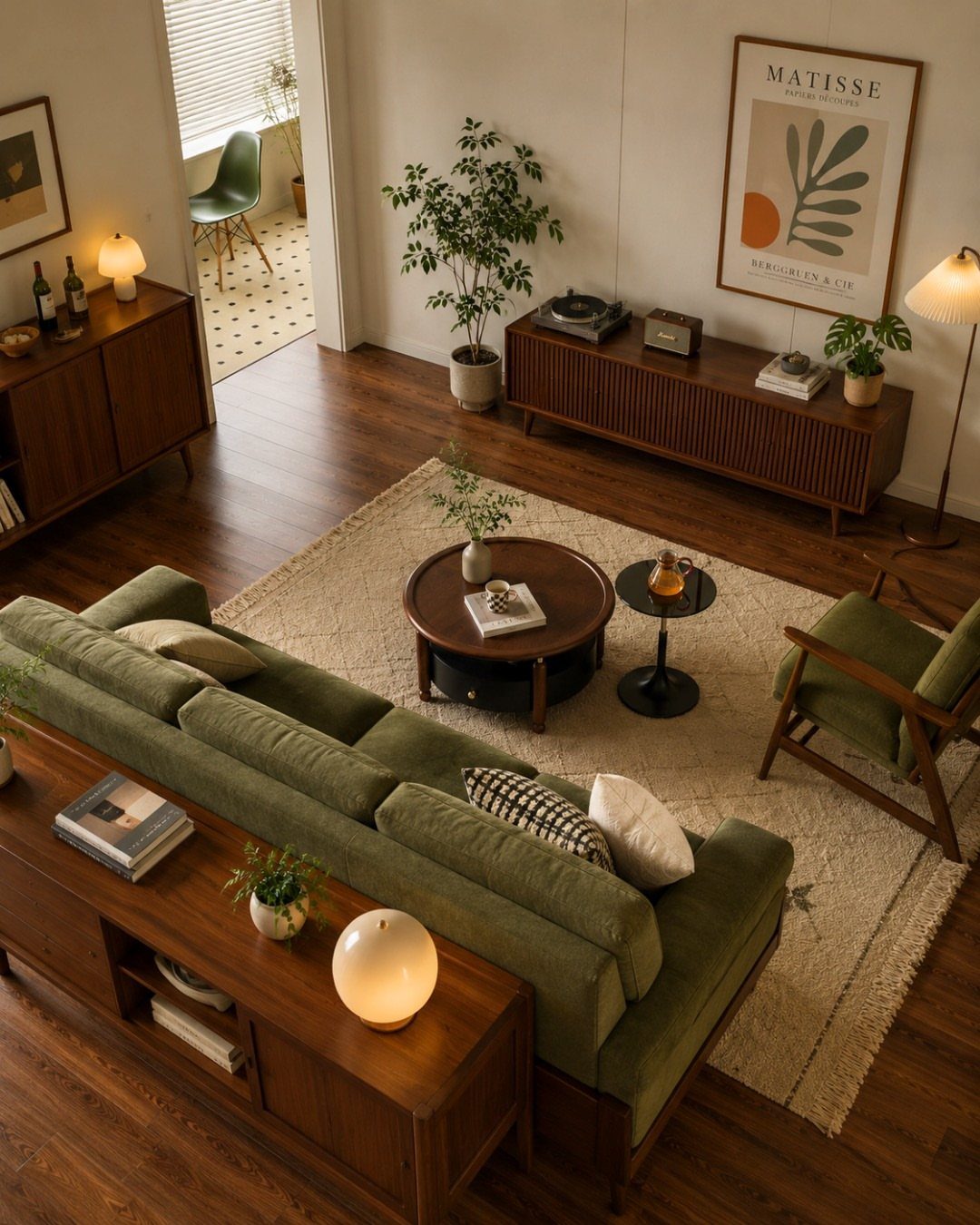 Muted green sofa and armchair with wooden frames in a brown toned living room.