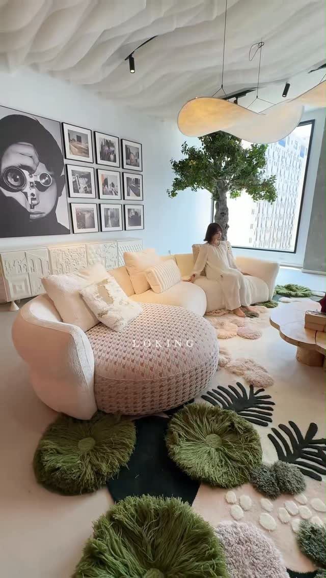 Abstract rug with green palm leaves in a modern white living room.