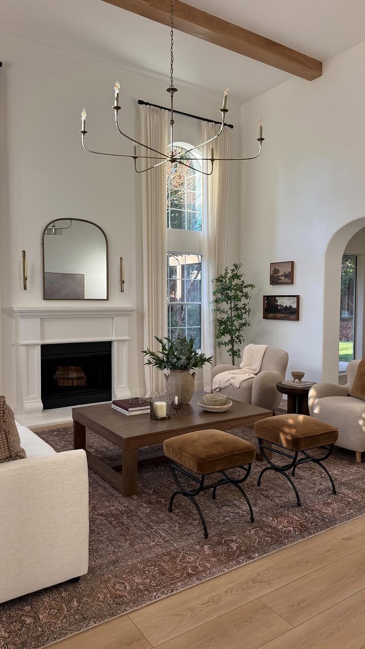 Large brown patterned rug anchoring a farmhouse living room with cream furniture.