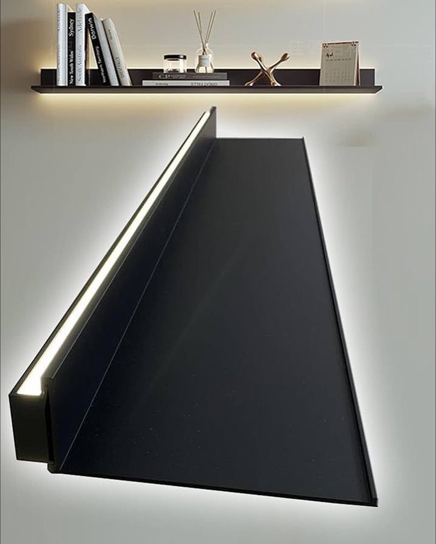 Black floating shelves with integrated LED lighting mounted on a white wall.