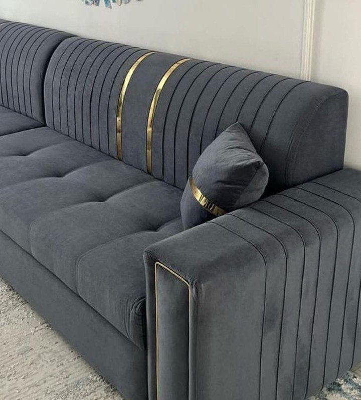 15 Grey Sofa Living Room Ideas with Real Style 8 Charcoal grey velvet sofa with gold accents and a matching throw pillow.