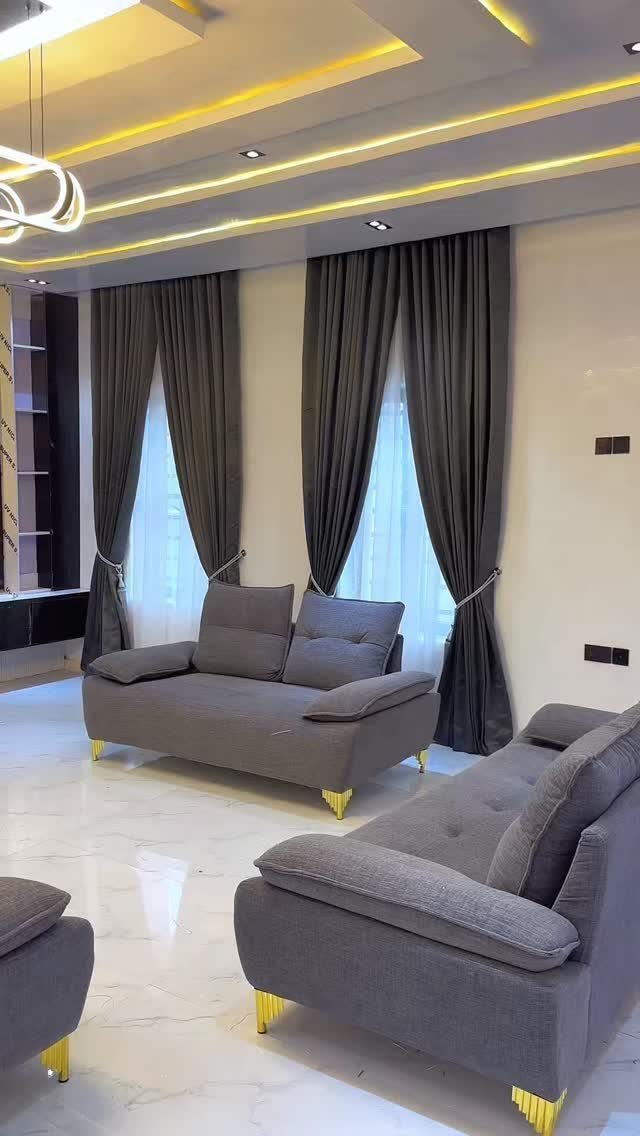 15 Grey Sofa Living Room Ideas with Real Style 12 Grey fabric sofas with gold legs in a room with dark grey curtains.