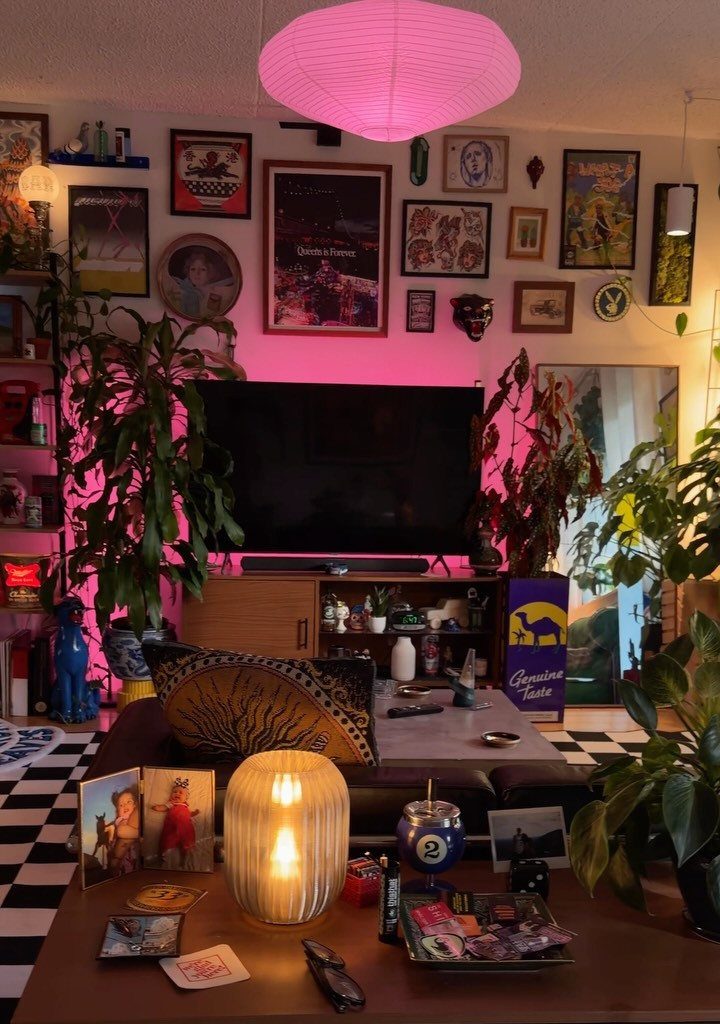 Eclectic living room with a pink lantern, gallery wall, and checkered flooring.