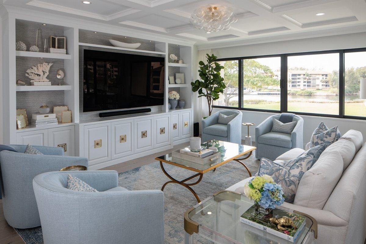 Light blue living room featuring gold cabinet hardware and a gold-framed glass coffee table.