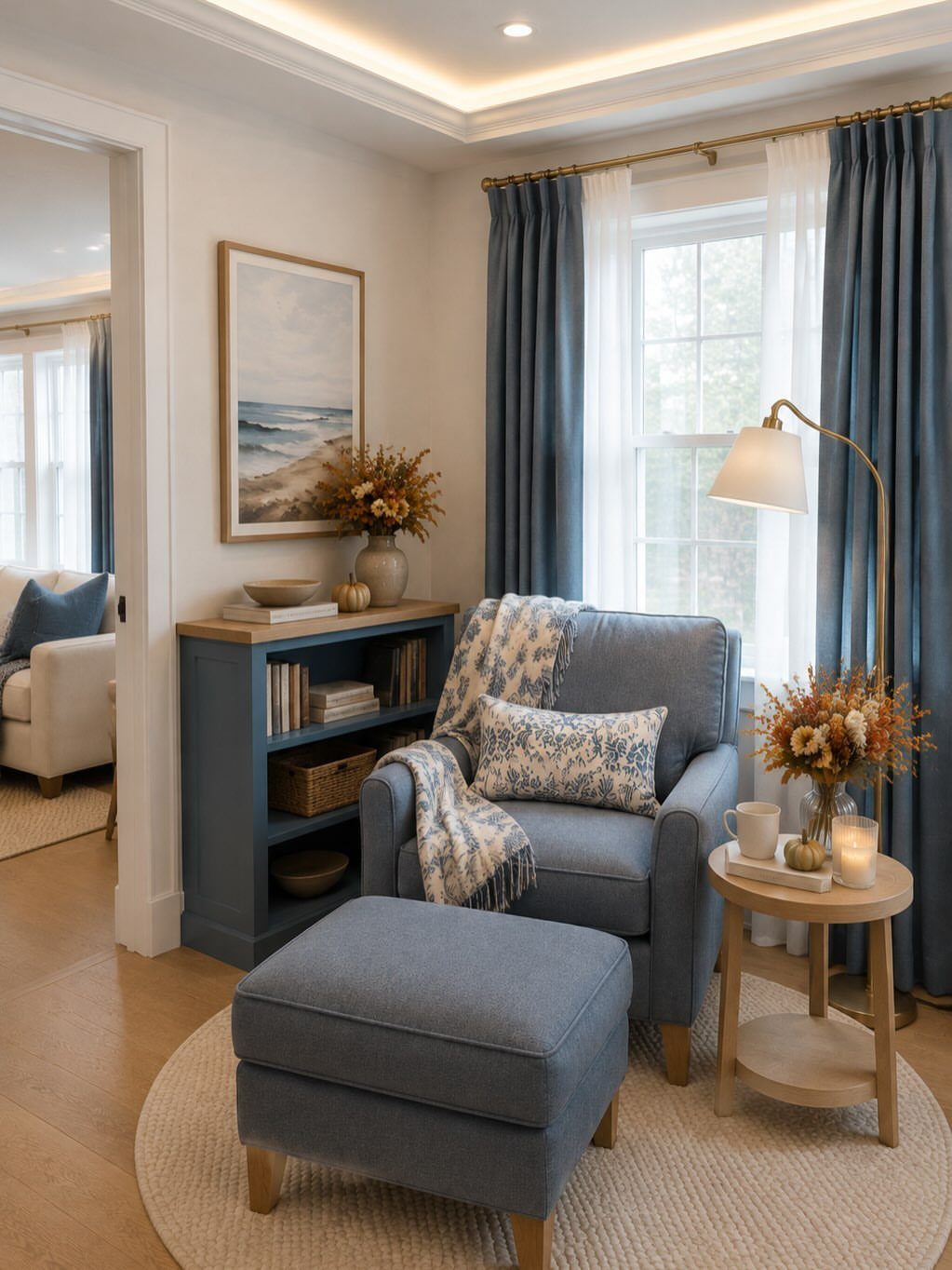 Blue armchair and ottoman in a room with warm white trim and molding.