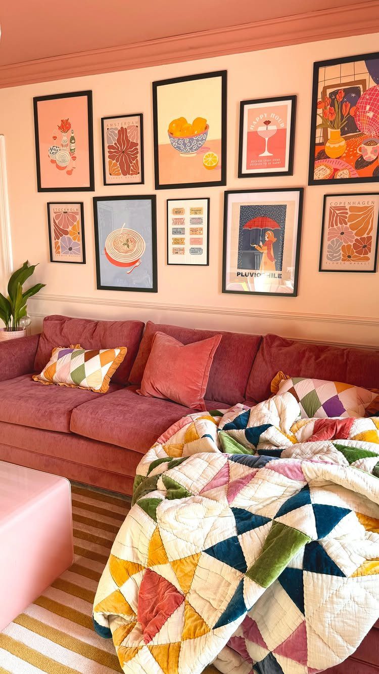9 Living Room Couch Ideas for a Stylish Space 8 Pink fabric sofa with colorful pillows and a quilt against a gallery wall.