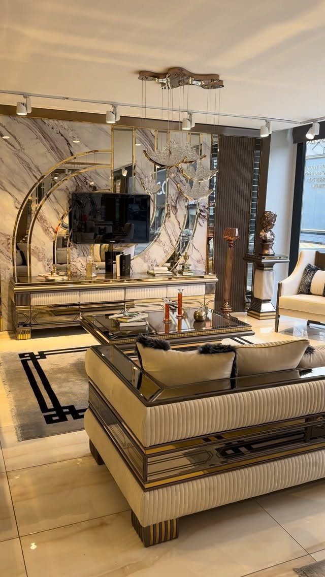Luxurious living room with a beige ribbed sofa, gold accents, and marble walls.