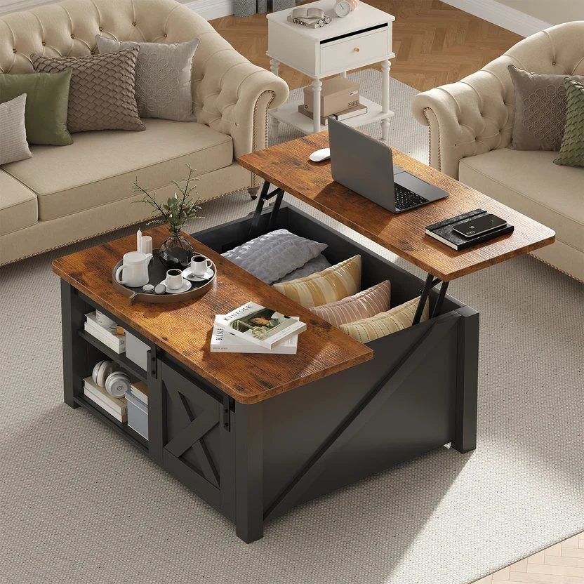 Lift-top coffee table with wooden surface and black base holding a laptop and pillows.