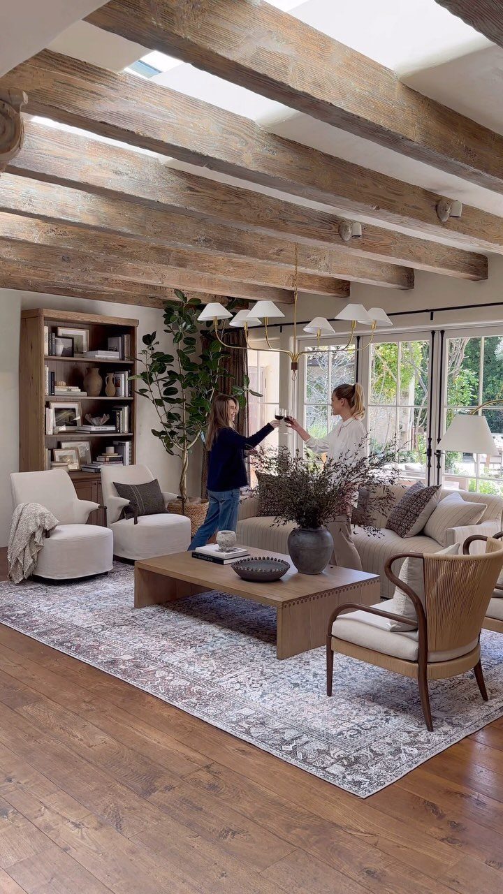 11 Living Room Ideas with Accent Chairs 9 Living room with exposed beams, a neutral sofa, and several stylish accent chairs.