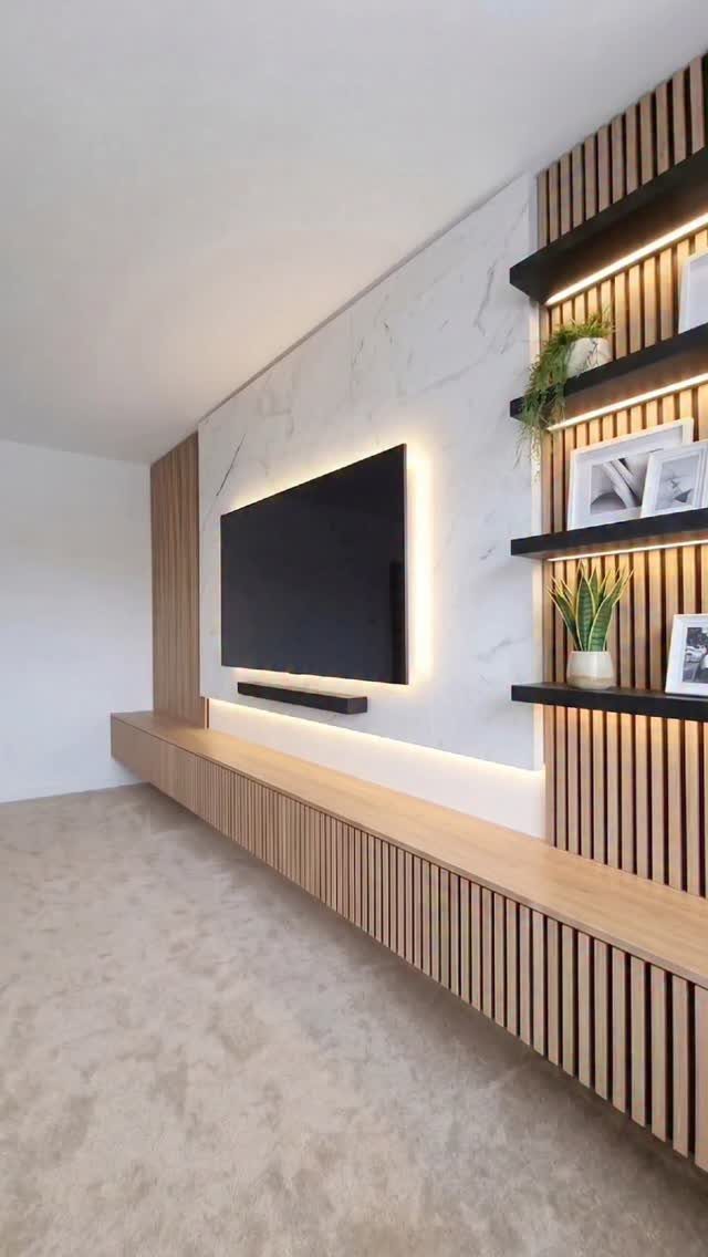 Modern living room with a long wooden floating console and black open shelves.