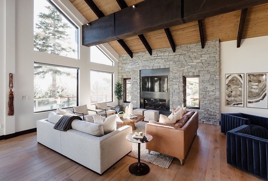 Living room with a mix of grey fabric, tan leather, and blue velvet seating.